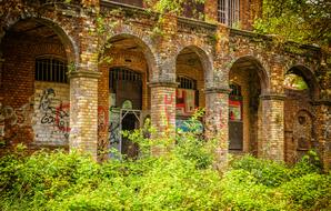 graffiti and inscriptions on an abandoned brick building