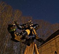 Close-up of the shiny microscope in light, near the trees