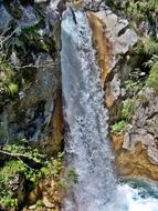 beautiful waterfall on the rocks in the forest