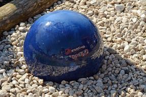 blue ball on the beach in the rocks