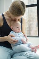 mother and child are sitting by the window