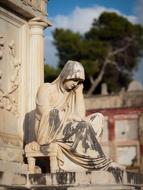 stone tombstone with sculpture