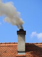 a stone roof with a chimney and a fire.