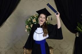 a student with a diploma is happy