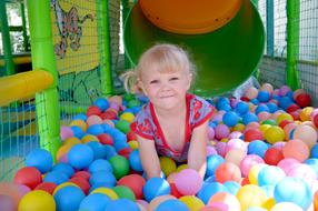 girl in the pool with colorful balls