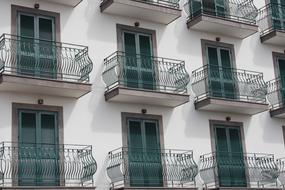 beautiful balconies with forged bars on the facade of a building in Europe