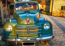 green vintage car on the street