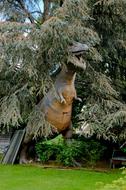 dinosaur sculpture in the trees