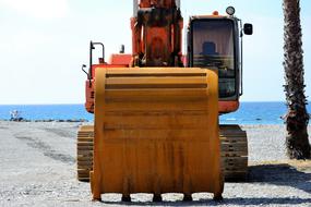 construction excavator by the sea