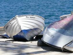 boats parked on the beach by the sea