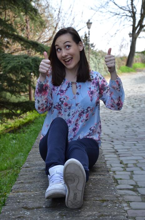 picture of a happy girl sitting on the road