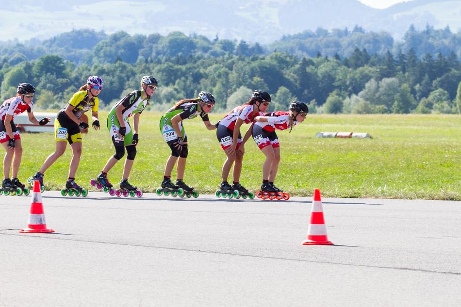 people on roller skates by the road