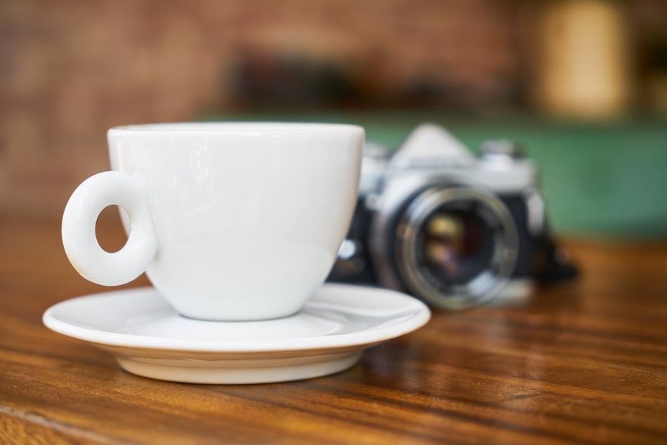 old camera on the table with a mug
