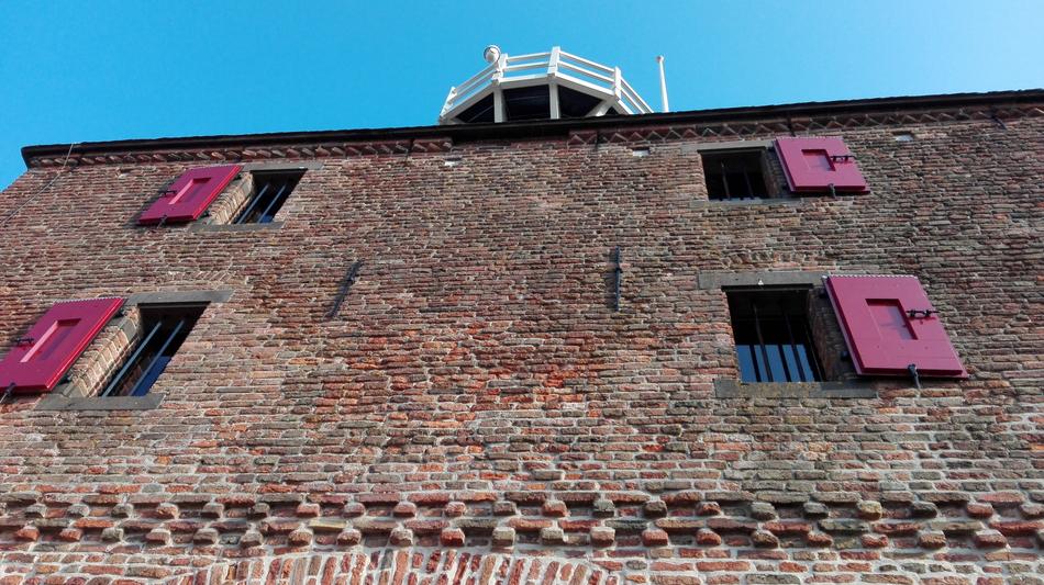 old house with pink shutters on the windows