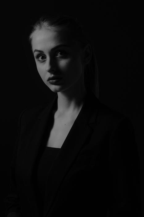 monochrome photo of a girl in a black jacket