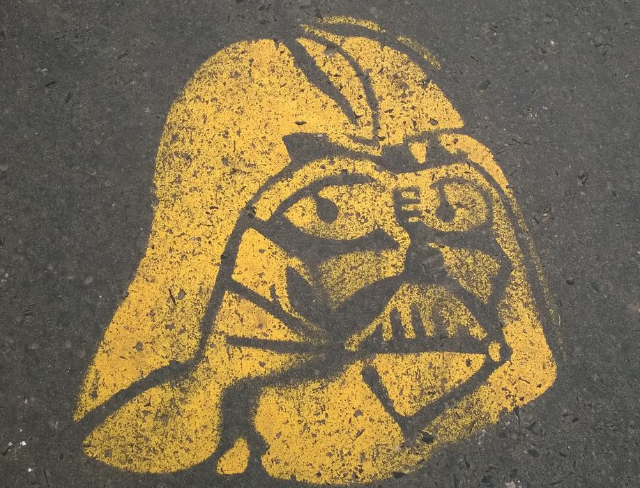 yellow graffiti on the pavement