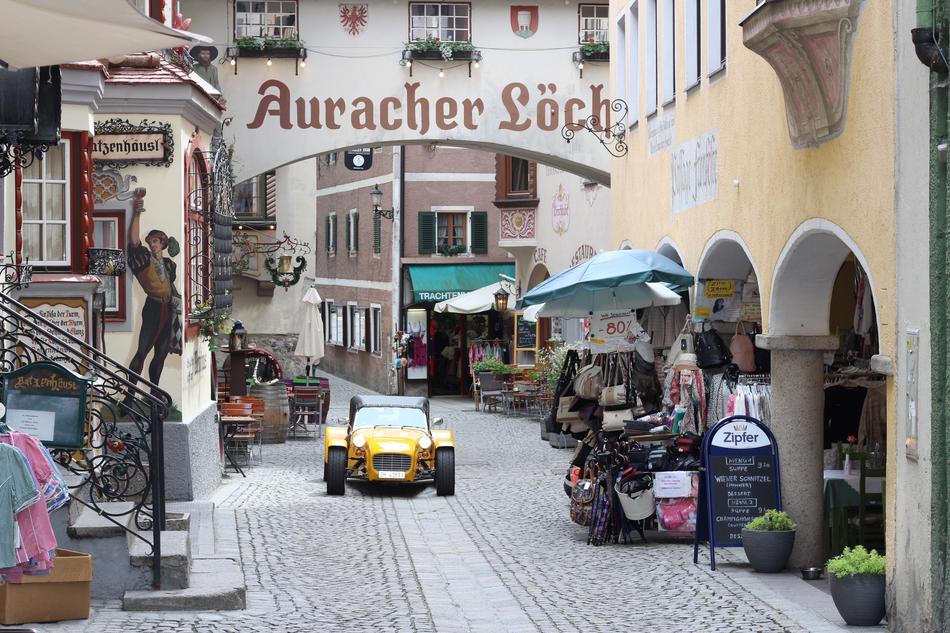little yellow car on a colorful street