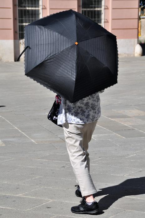 black umbrella with a man on a walk