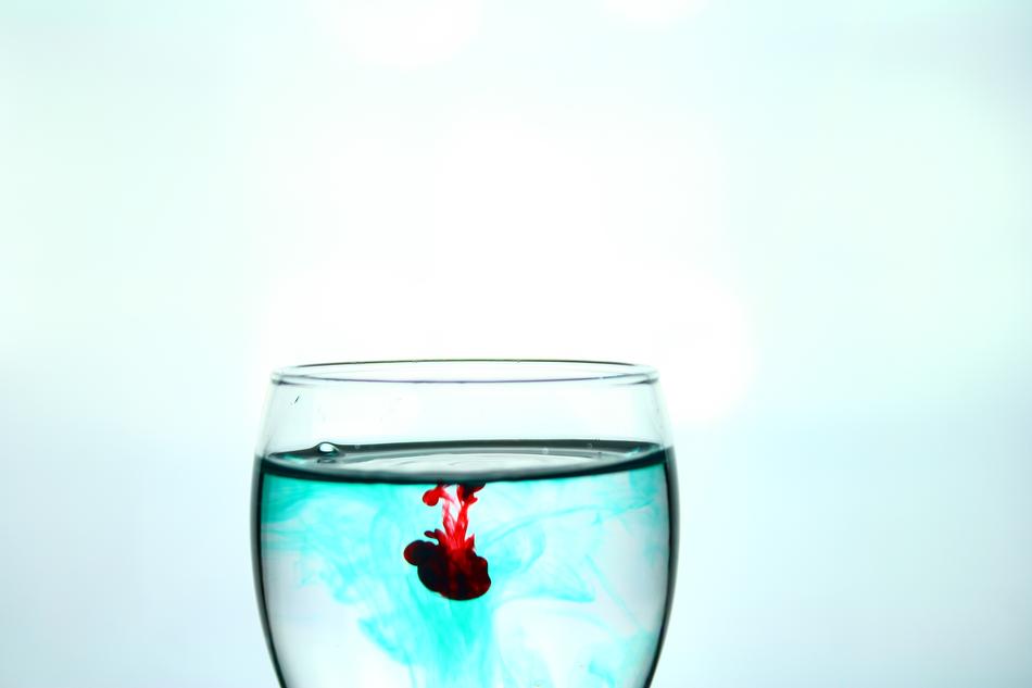 red paint in a glass of water