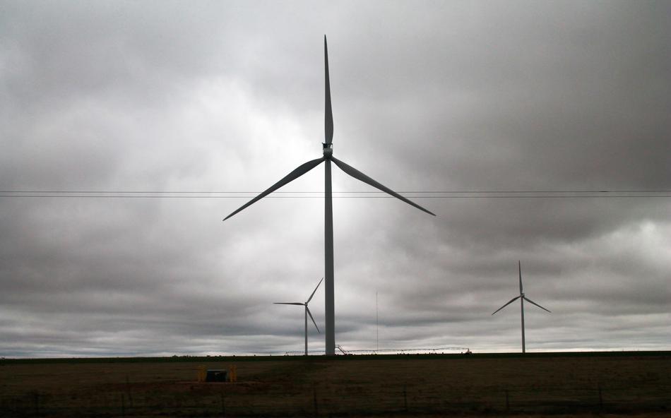 Wind mills on the beautiful fields in Texas, USA, under the cloudy sky