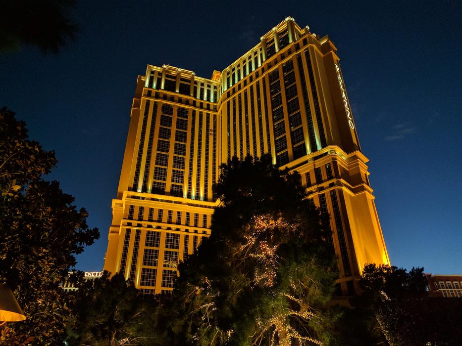 apartment building illuminated by lights at night