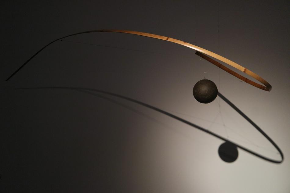 wooden hinged sculpture with a ball