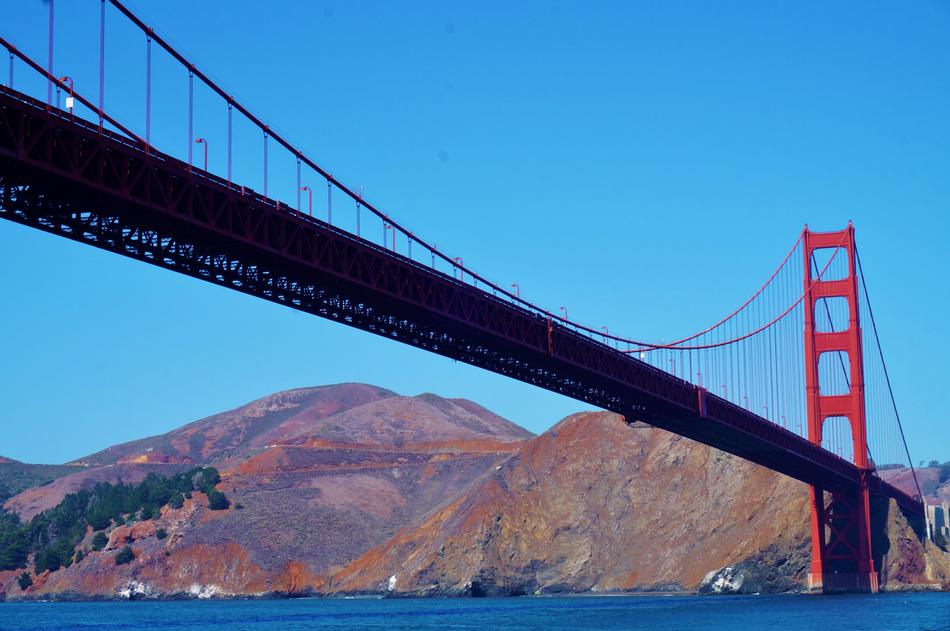 long bridge over the river with the mountains as a backdrop