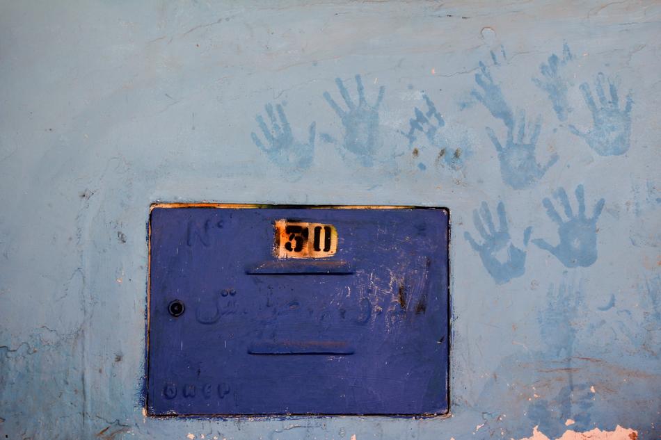 the handprints on the wall are blue