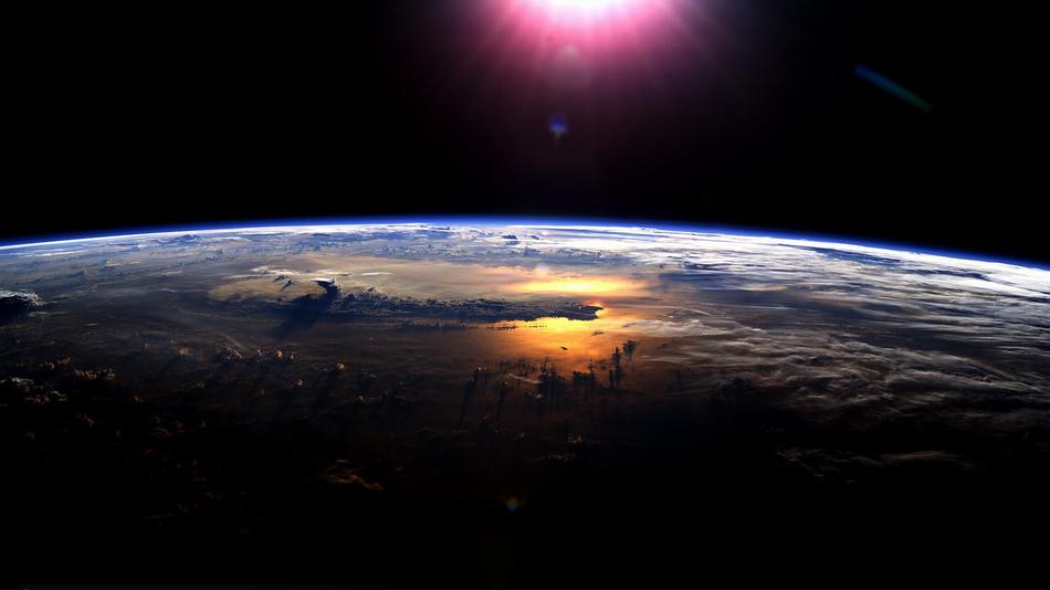 burning sun over the earth in space