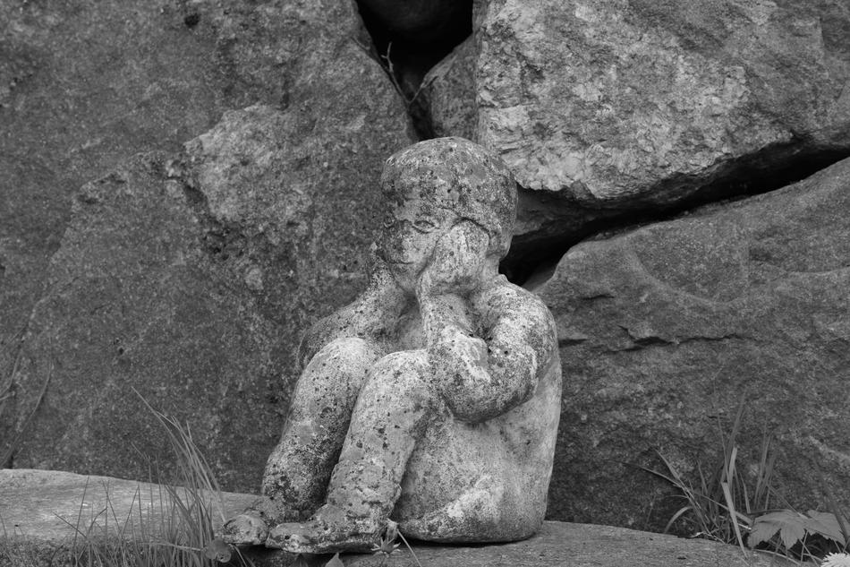 stone boy as sculpture in the cemetery