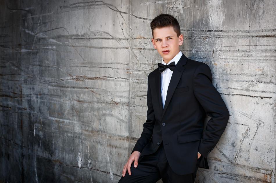 boy confirmation portrait grey wall
