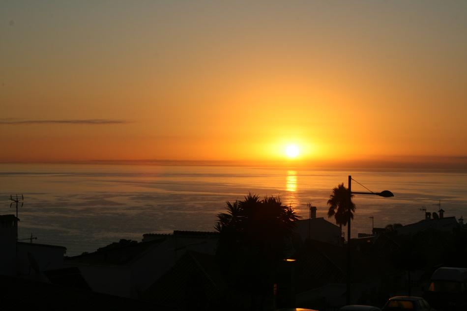 sea coast against the background of a fiery sunset