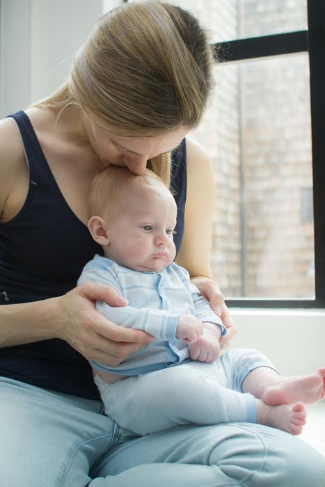 mother and child are sitting by the window