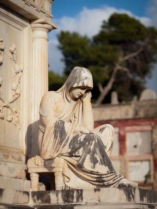 stone tombstone with sculpture