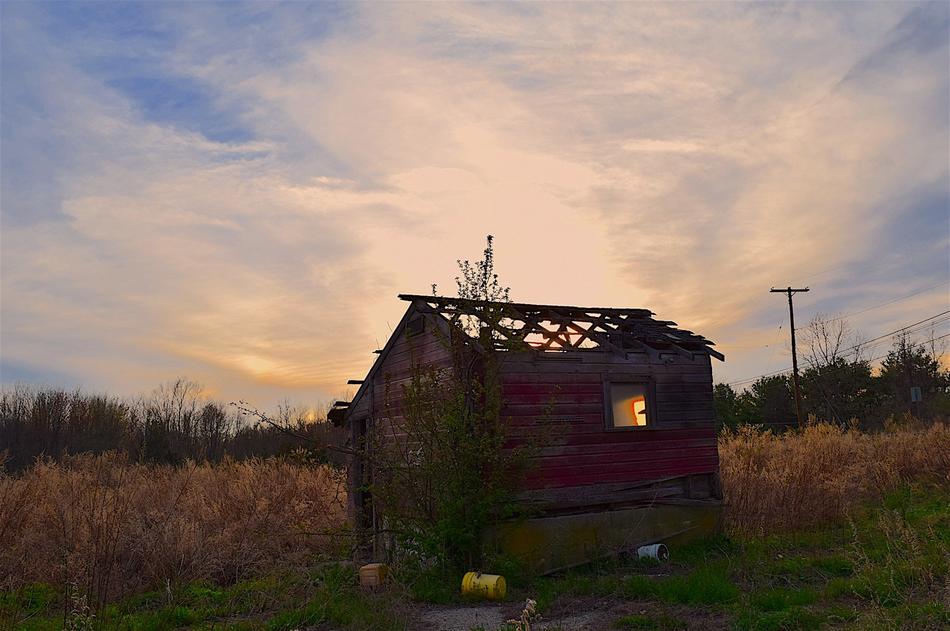 An old abandoned house in a field