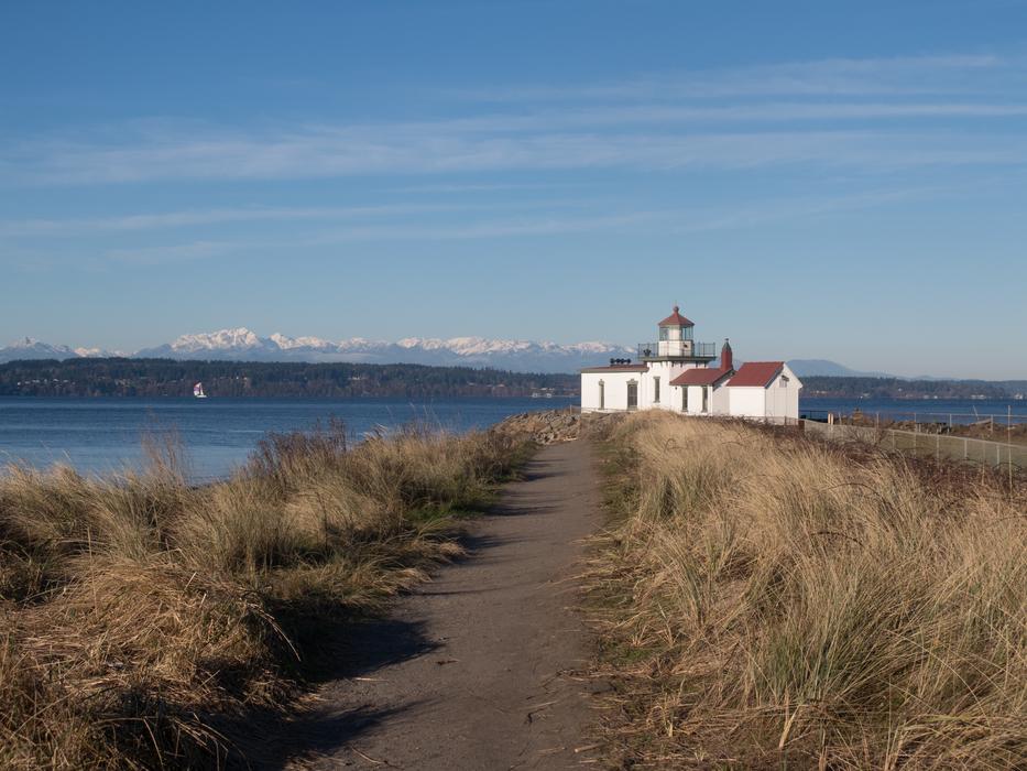 a house in the distance by the ocean