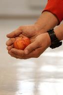 man is holding an apple in his hands