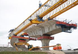 stone bridge with construction cranes