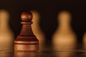 wooden figure on a chessboard