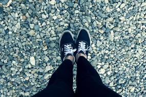 Feet of the woman, on the colorful stones