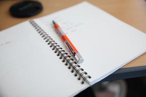 notebook with a pen on the table