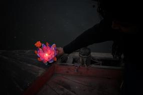 candle in a flower in hand