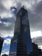 cloudy sky over skyscraper in manhattan