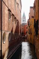 distant view from the canal to the bell tower in venice