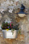 wall decorated with flowers and a lamp