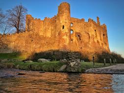 a big castle by the lake in the sunshine