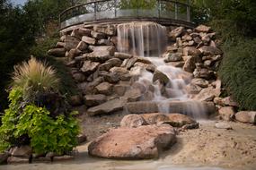 waterfall flowing down the rocks in the garden