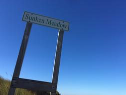 wooden plaque on the road