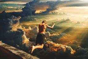 boy jumping from a roof into the clouds