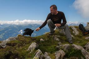 man with the crow on the rock